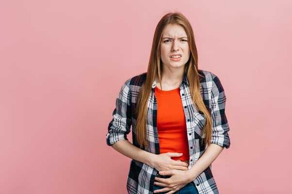 Woman holding her stomach in discomfort