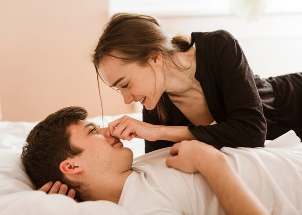 Couple in bed playing with each other