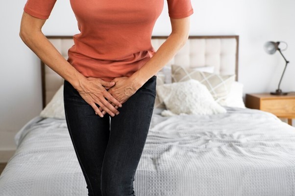 fully clother woman covering her pelvic area