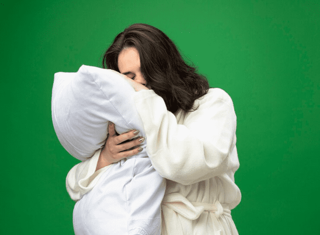 Female sleeping on pillow while standing