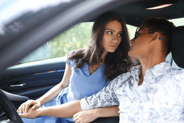 Couple passionately looking at each other in the car