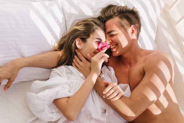 Couple laying side by side in bed