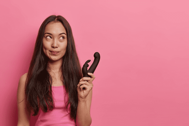 Woman holding a sex toy